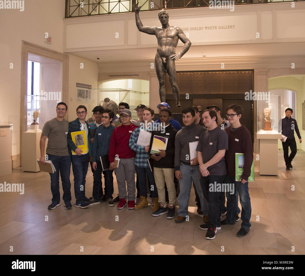 High School class of teenage boys pose for a photo in the Shelby White Gallery  Classical Art Collection at the Metropolitan Museum Of Art in NYC. Stock Photo