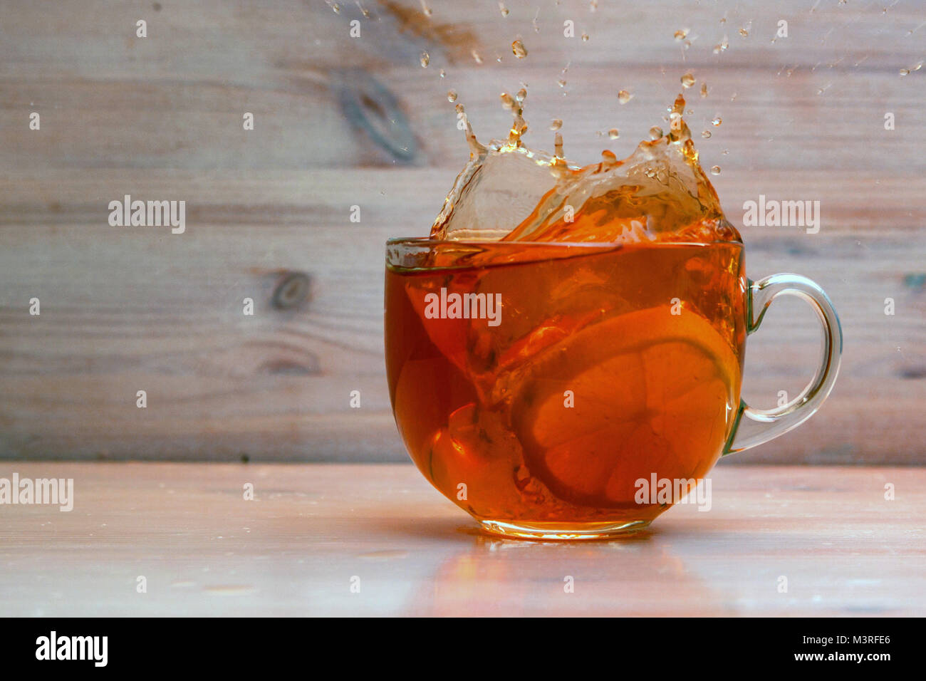 Adding lemon to tea in transparent cup stock photo alamy