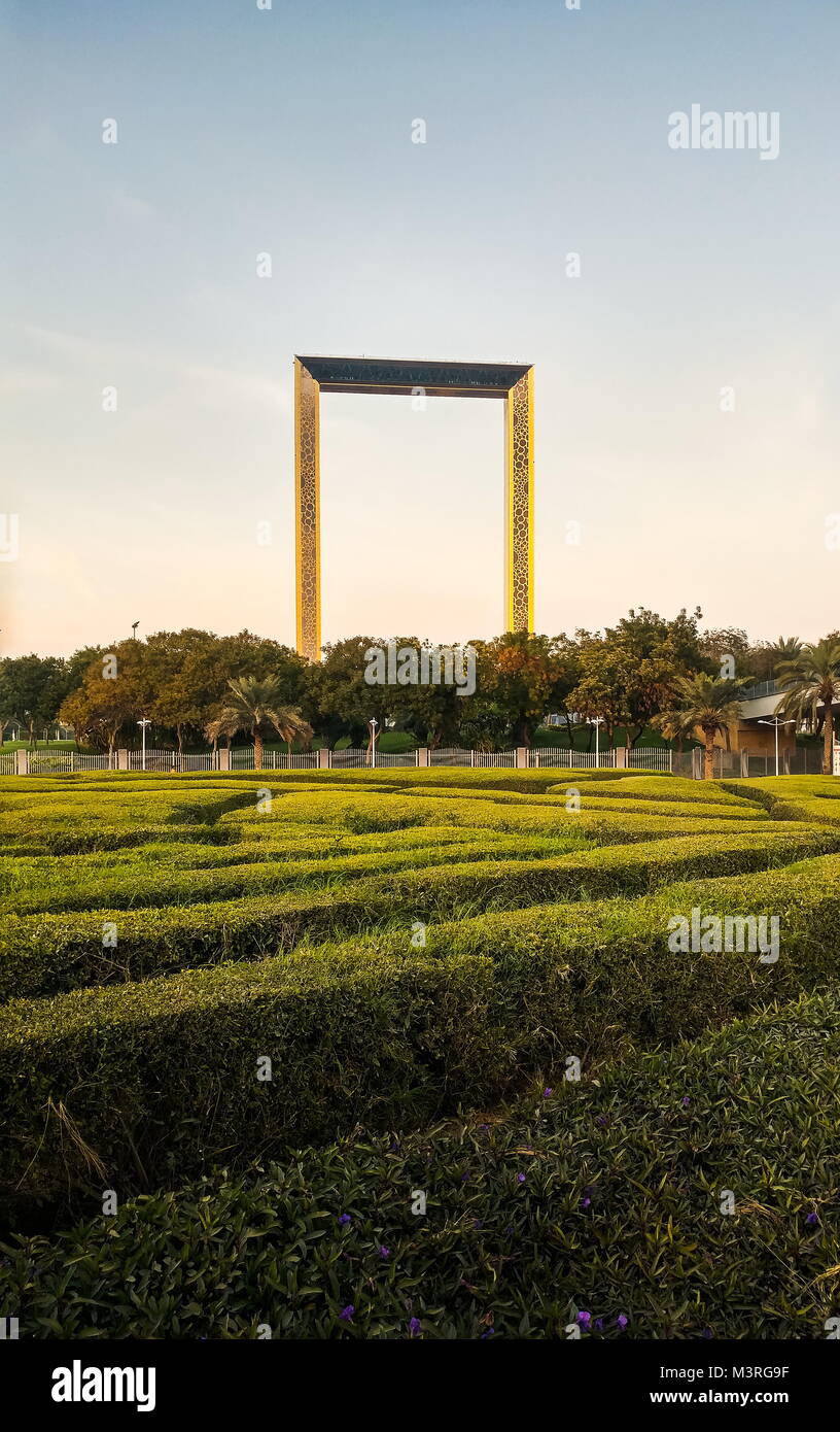 Dubai, United Arab Emirates, February 11, 2018: Dubai Frame building with palm trees at sunset. The frame measures 150 meters high and 93 meters wide  Stock Photo