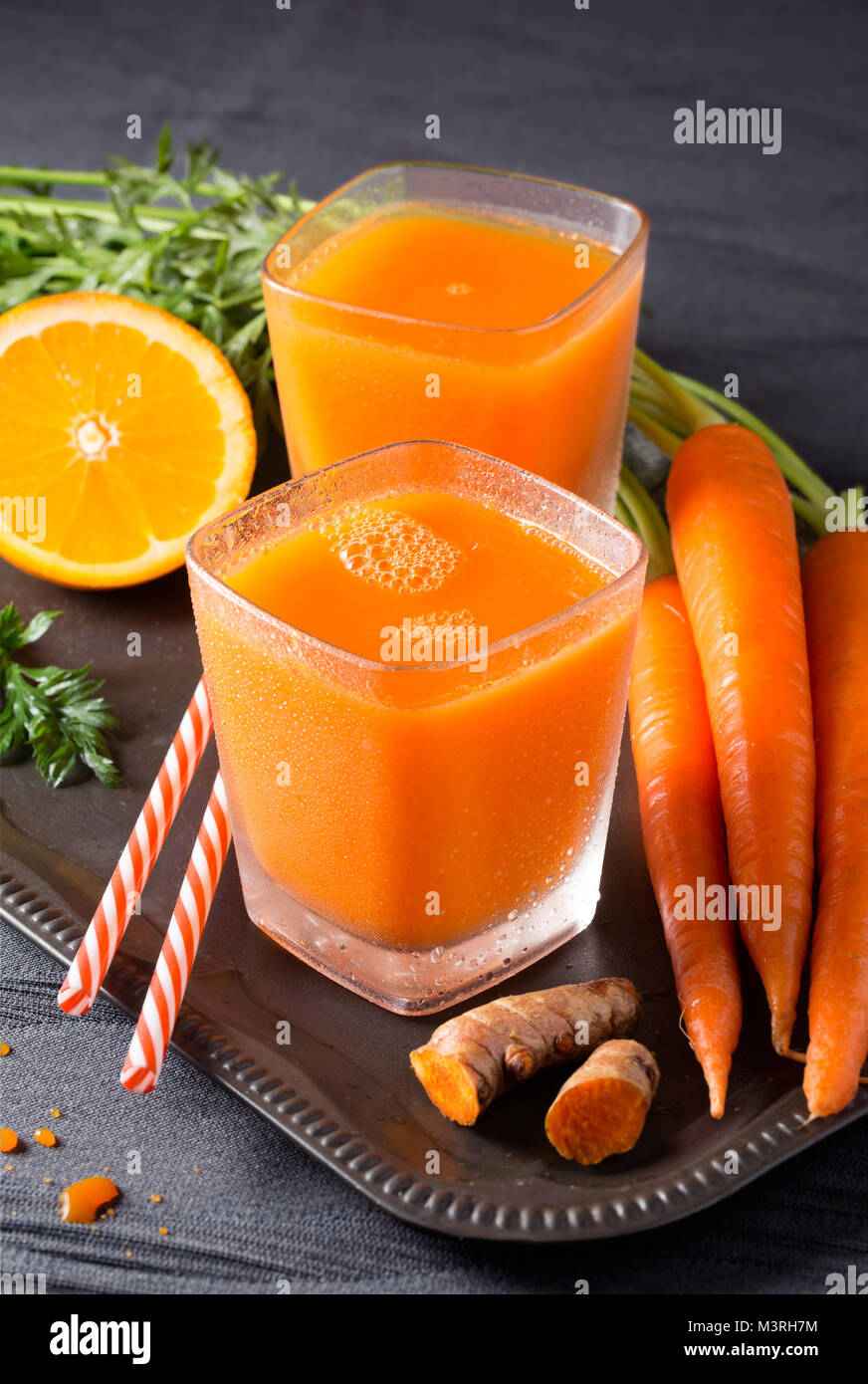 Fresh organic carrot-orange juice with turmeric root Stock Photo