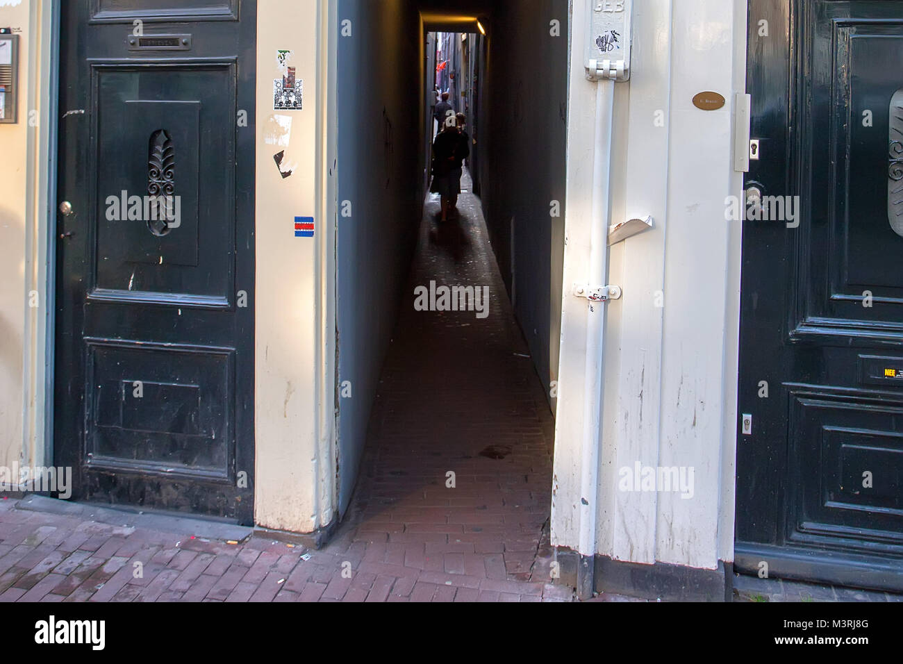 AMSTERDAM, THE NETHERLANDS - JUNE 10, 2014: Narrow passage in street in Amsterdam Stock Photo