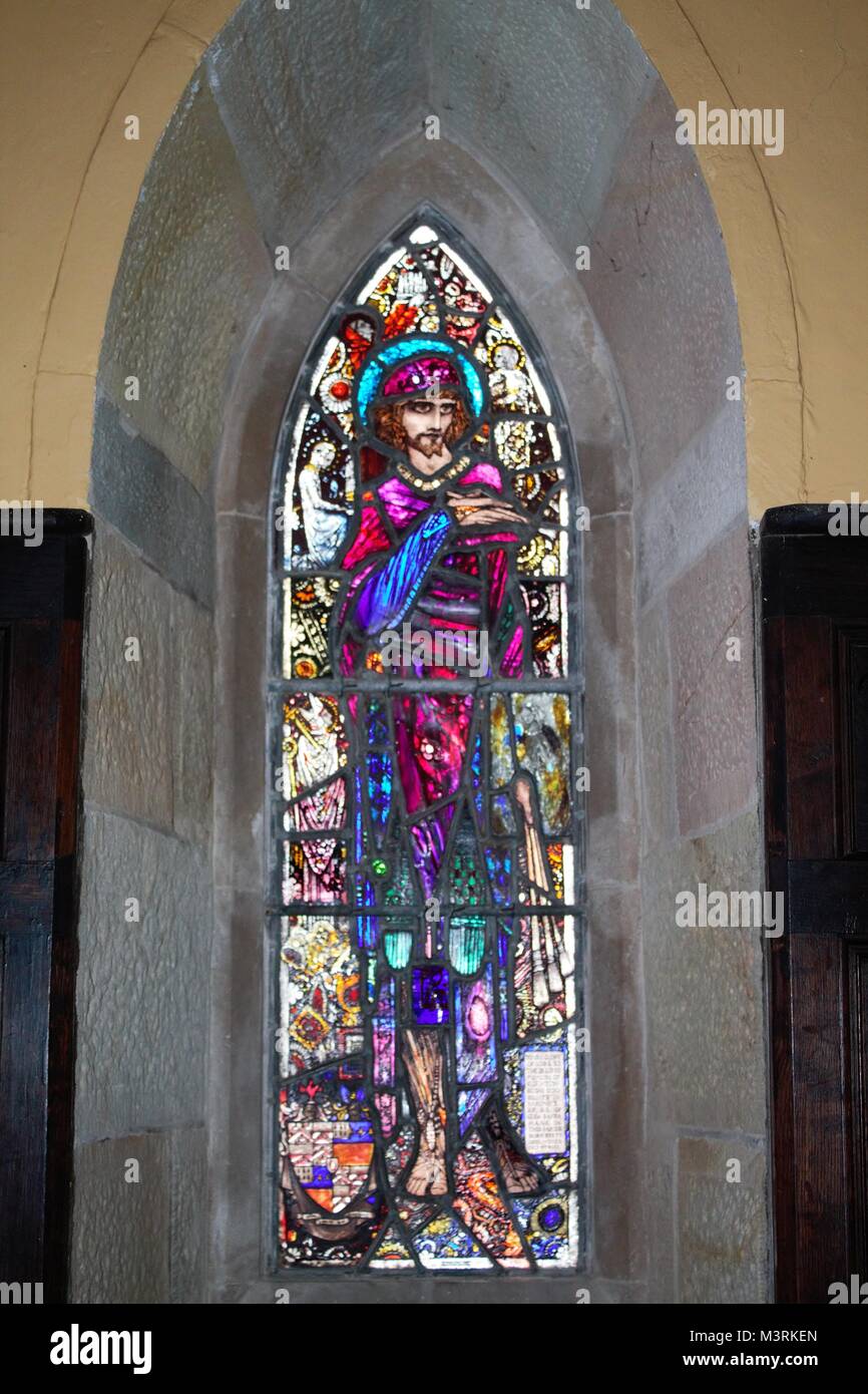 Stained glass figures in a small church by harry clarke in ireland