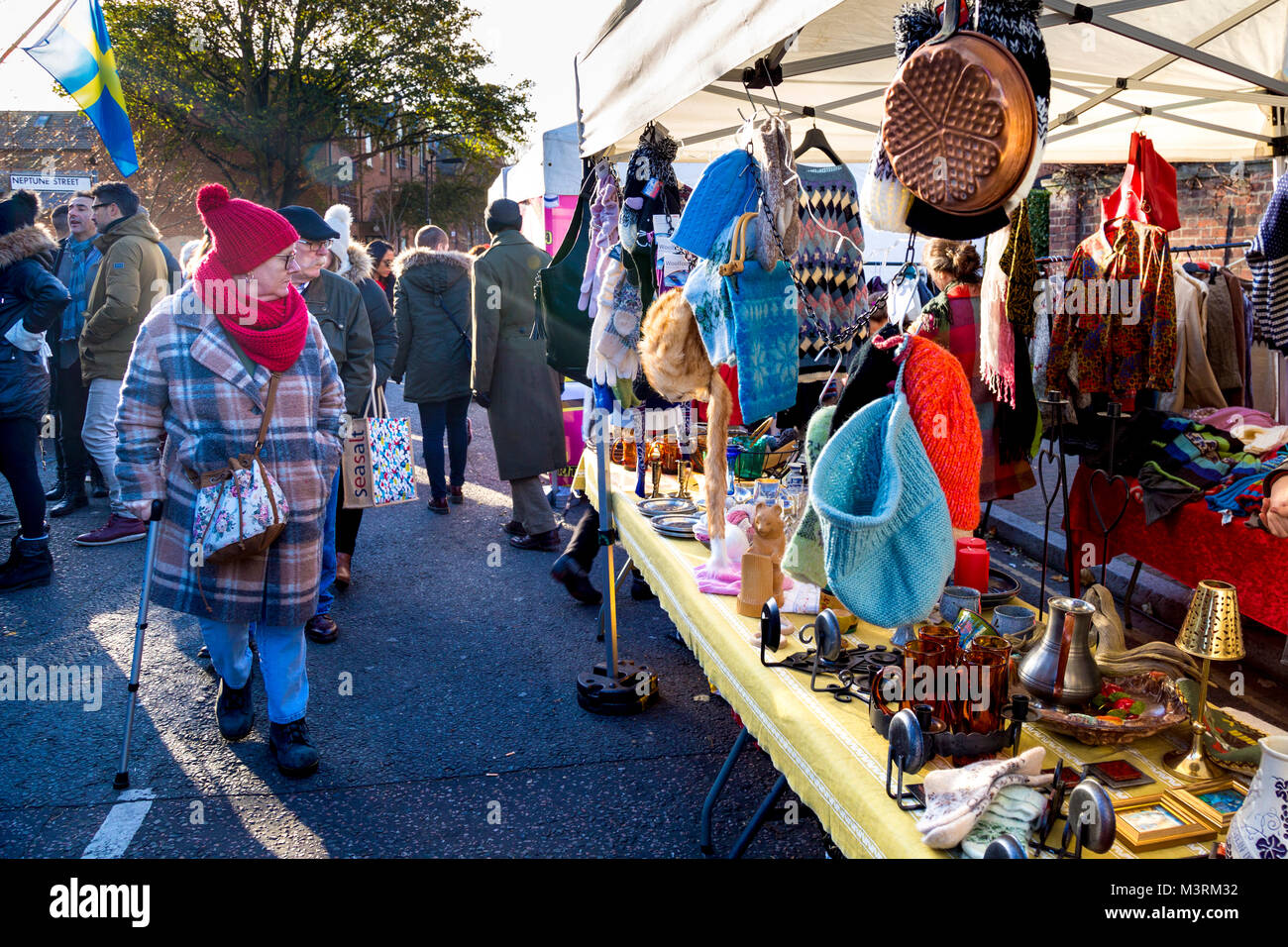 Visitors looking at tradition arts and crafts stall at the Scandinavian Christmas Market, London, UK Stock Photo