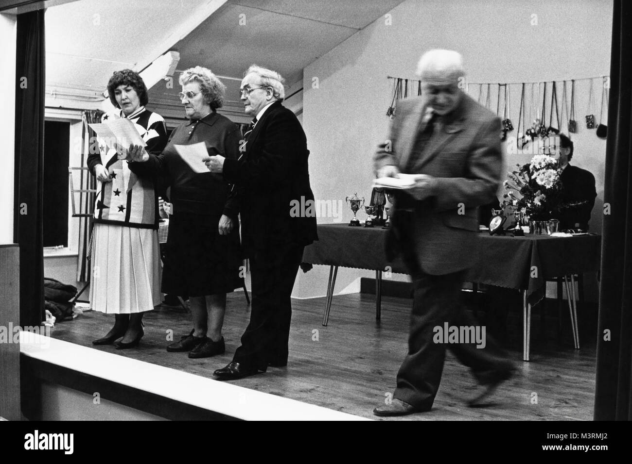 Performers on stage at small eisteddfod in village hall at Cwmdu Powys Wales UK Stock Photo