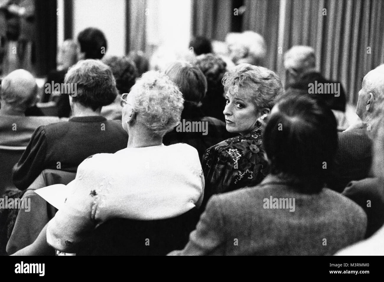 Lady in audience at small eisteddfod in village hall at Cwmdu Powys Wales UK Stock Photo