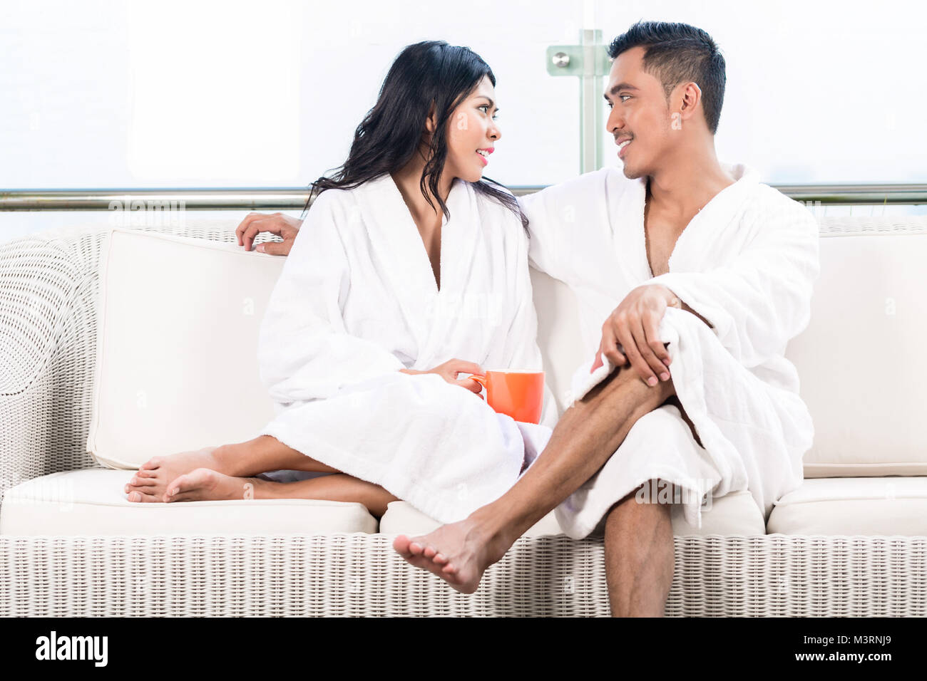 Couple in morning sitting on couch Stock Photo