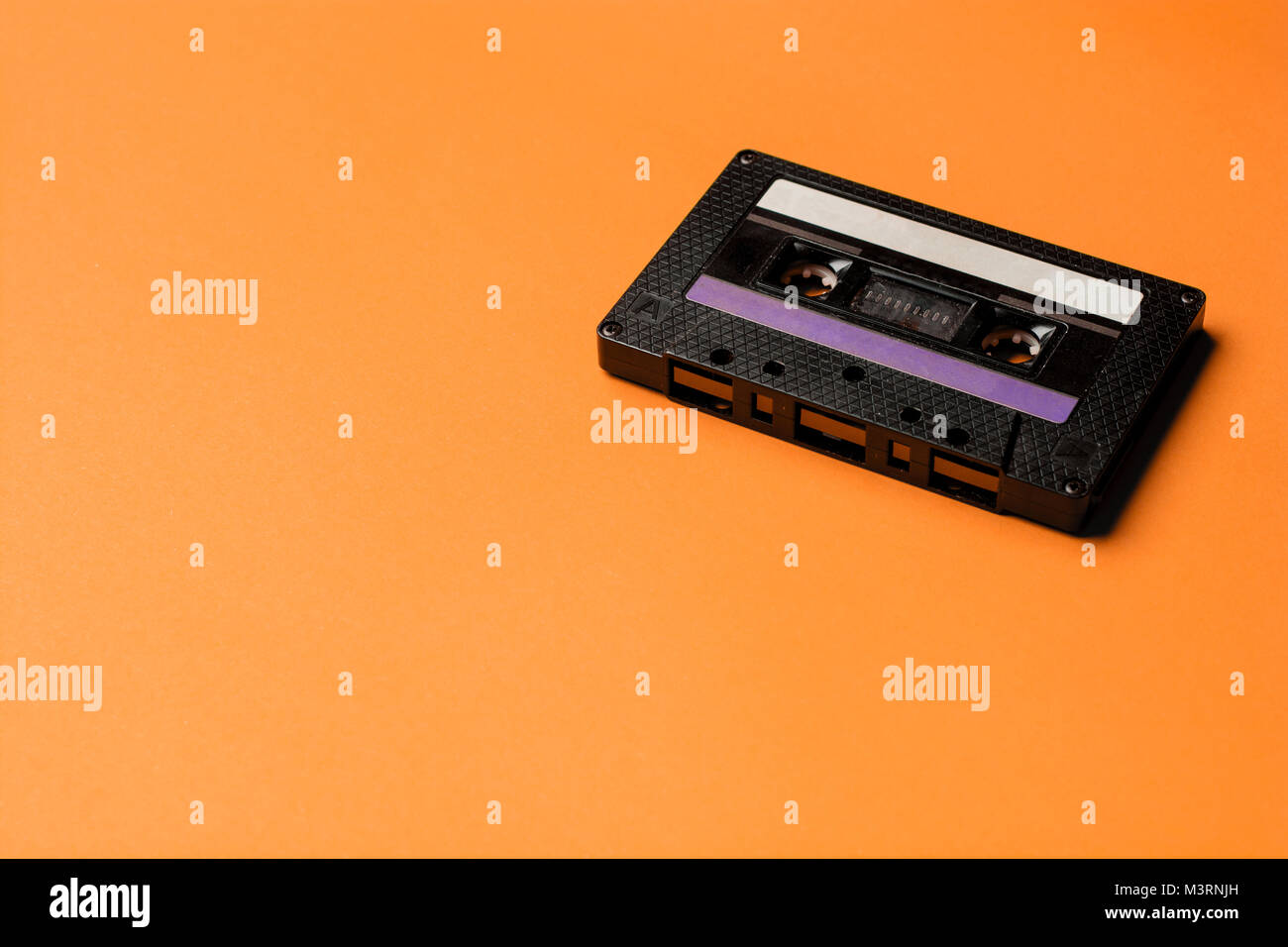 Retro cassette tape over orange background. top view. copy space Stock