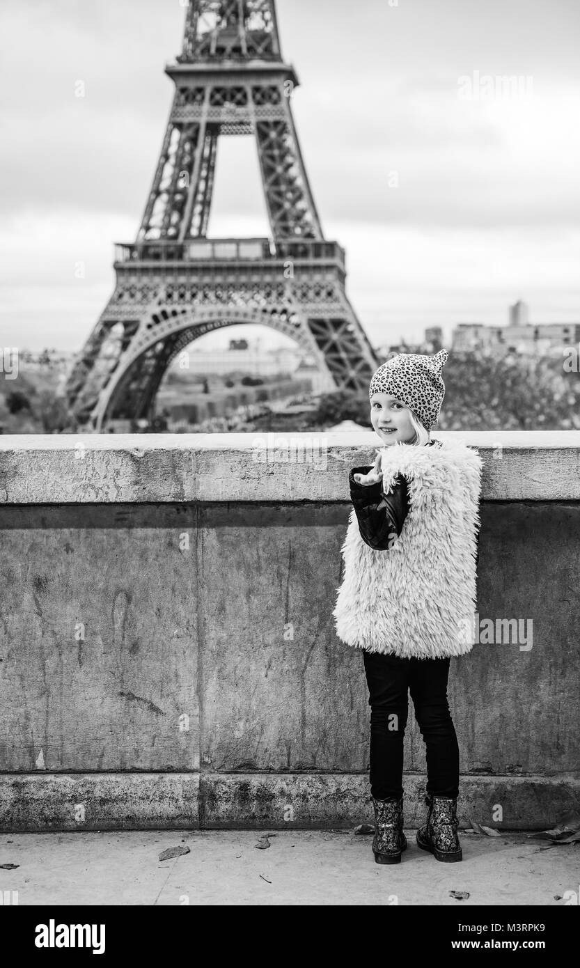 Bold Winter in Paris. Full length portrait of happy trendy child  calling to see Eiffel tower. Paris, France Stock Photo