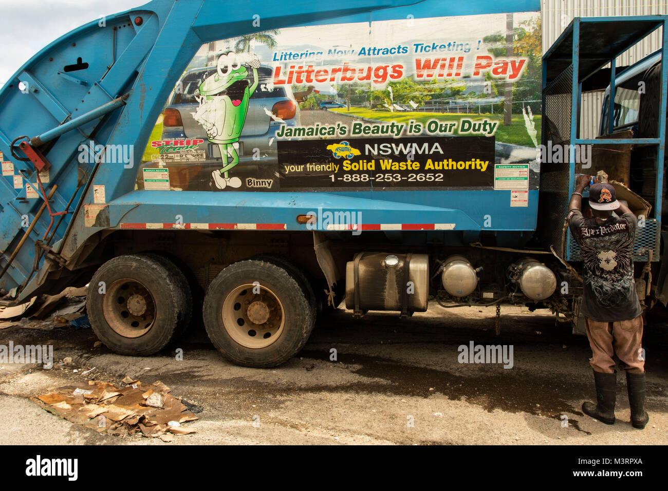 garbage truck and operative cleaning up the waste outside Ocho Rios market, Ocho Rios, Jamaica