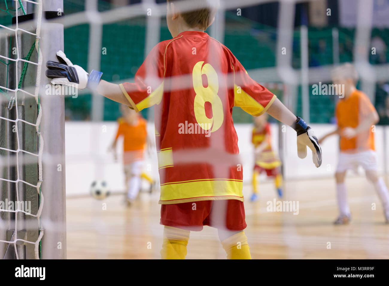 Football futsal training for children. Indoor football goalkeeper