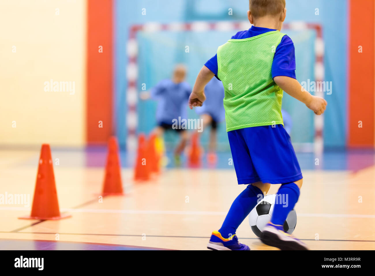 Soccer training dribbling cone drill. Football futsal training for