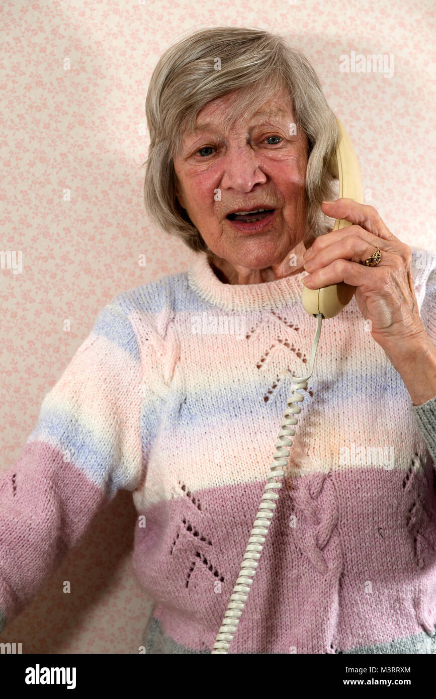 Woman talking on landline phone hi-res stock photography and images - Alamy