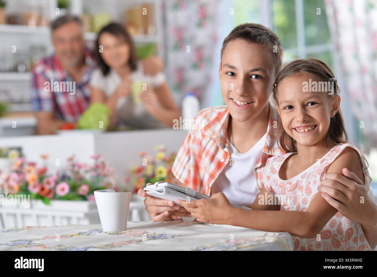 Brother and sister using tablet Stock Photo - Alamy