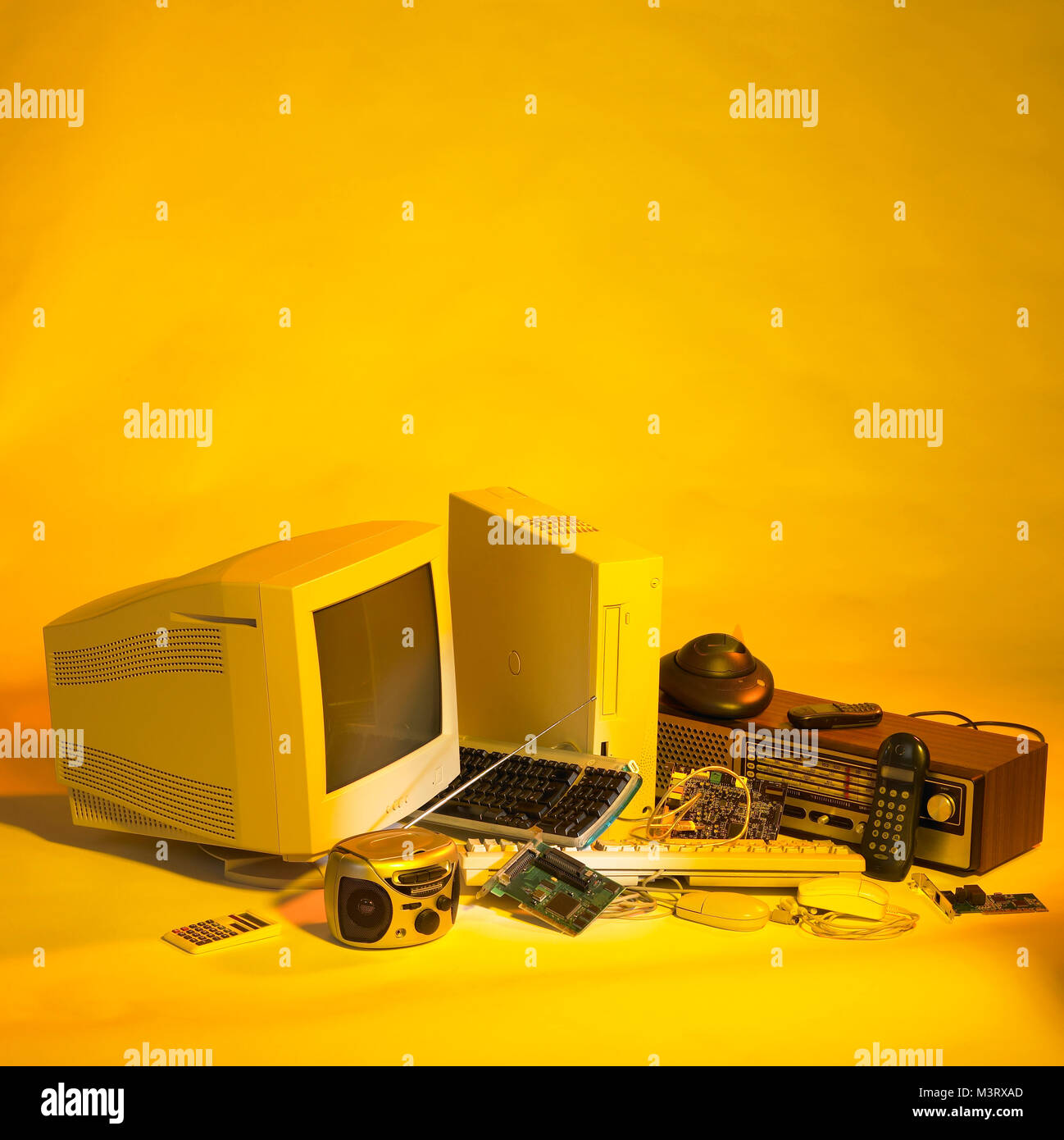 various electronic scrap in yellow ambiance Stock Photo