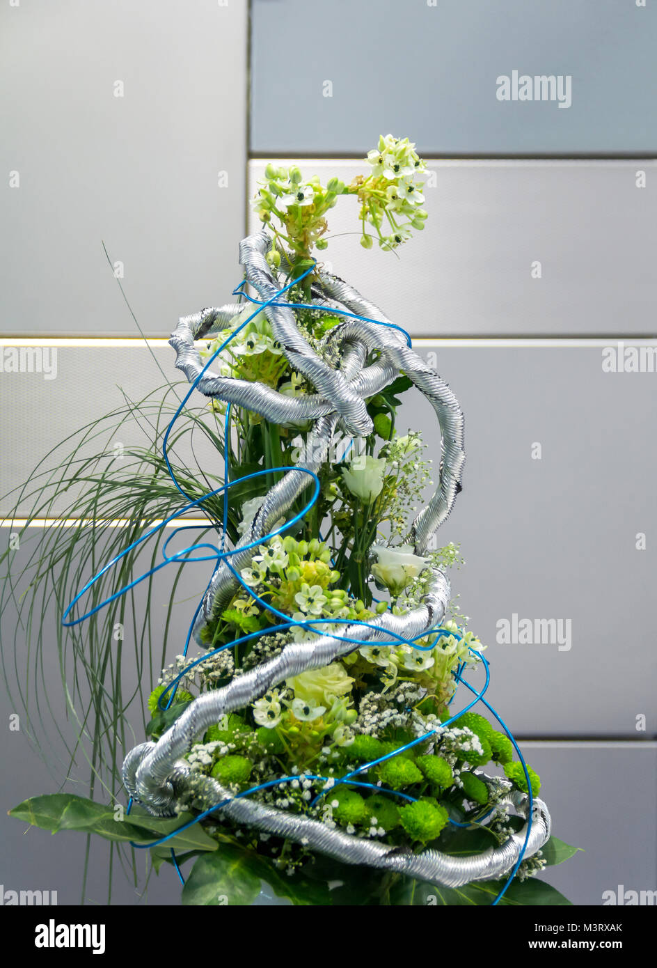 flower arrangement in front of various steel panels with different surfaces Stock Photo