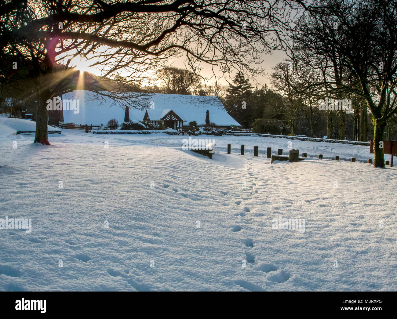 Winter scene Rivington Hall Barn near Horwich Bolton UK covered in snow as the sun rises on another frosty day Stock Photo