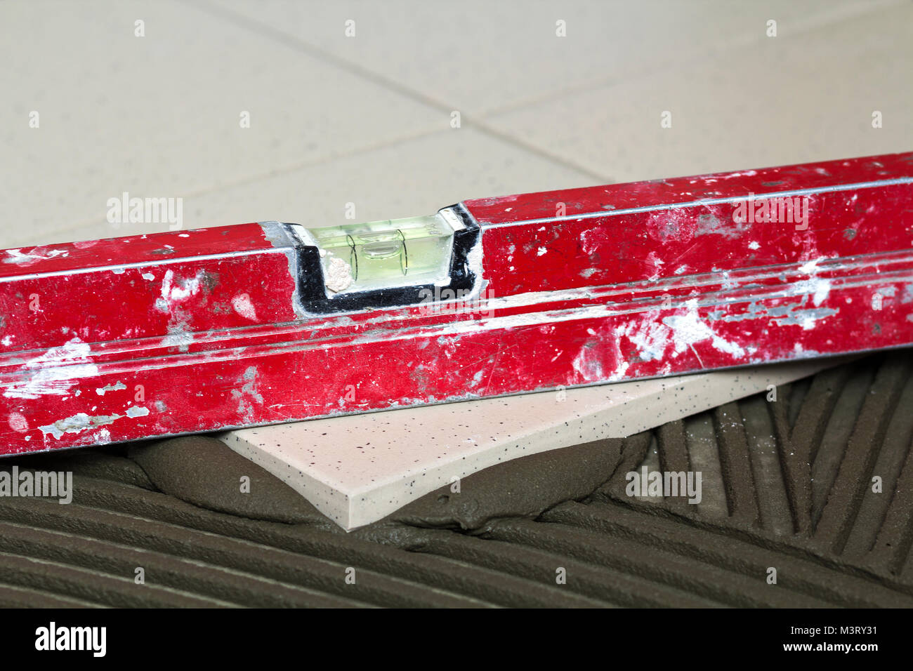 Ceramic tiles and tools for tiler. Floor tiles installation. Home