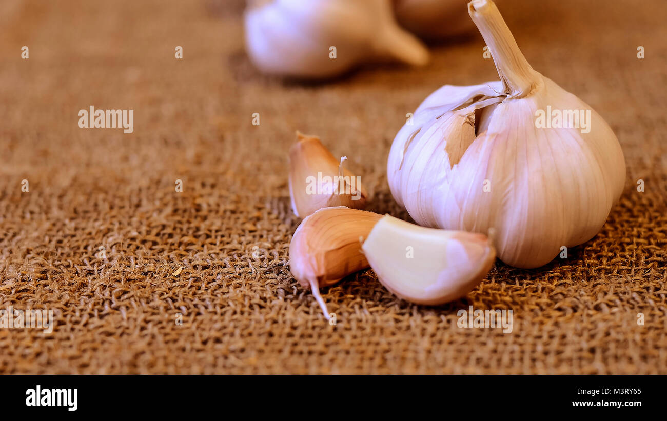 Garlic and cloves lying on a napkin. Healthy food and spices. Ad Stock ...