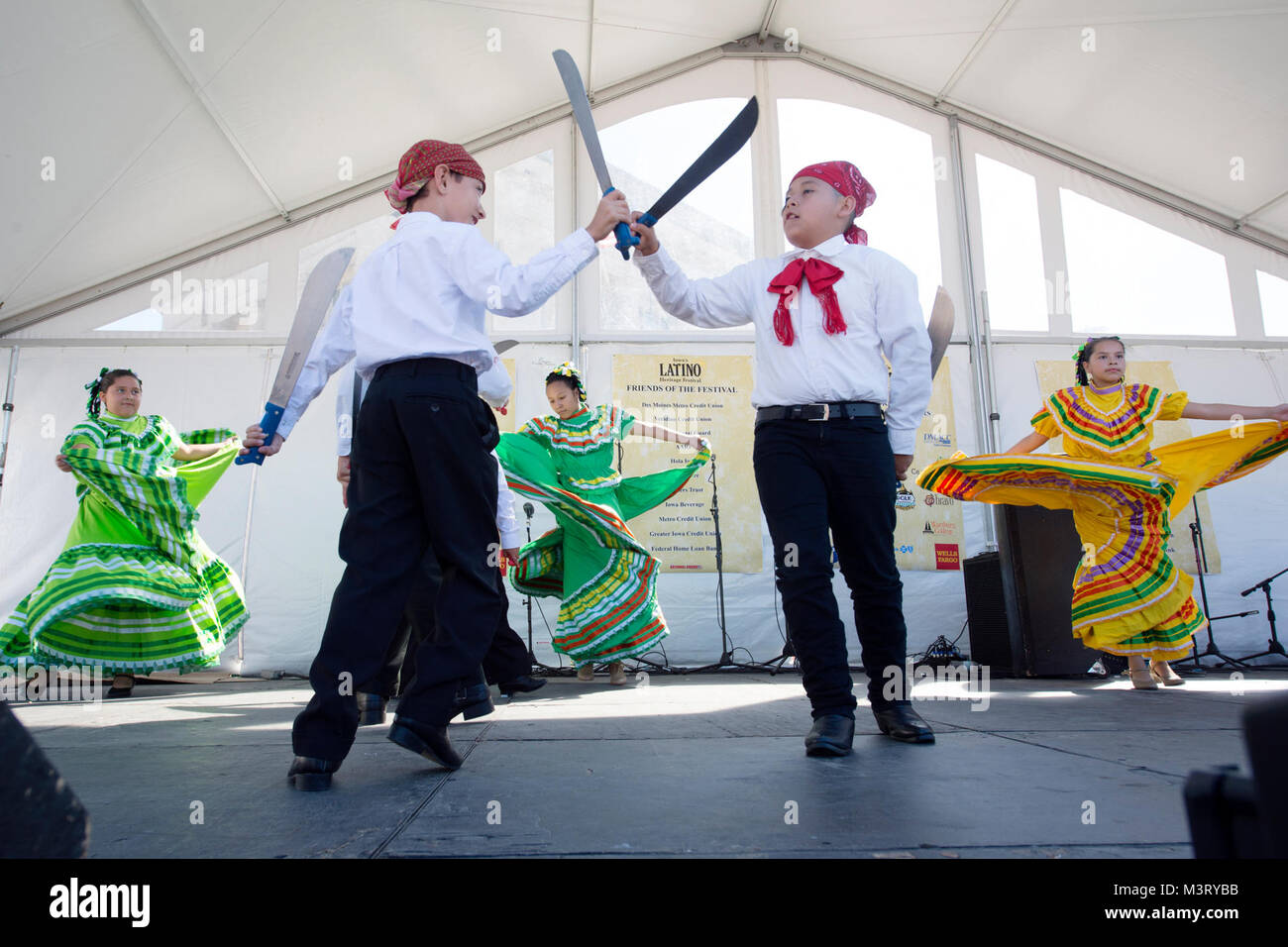 Children perform the traditional Machete Dance during the annual Latino