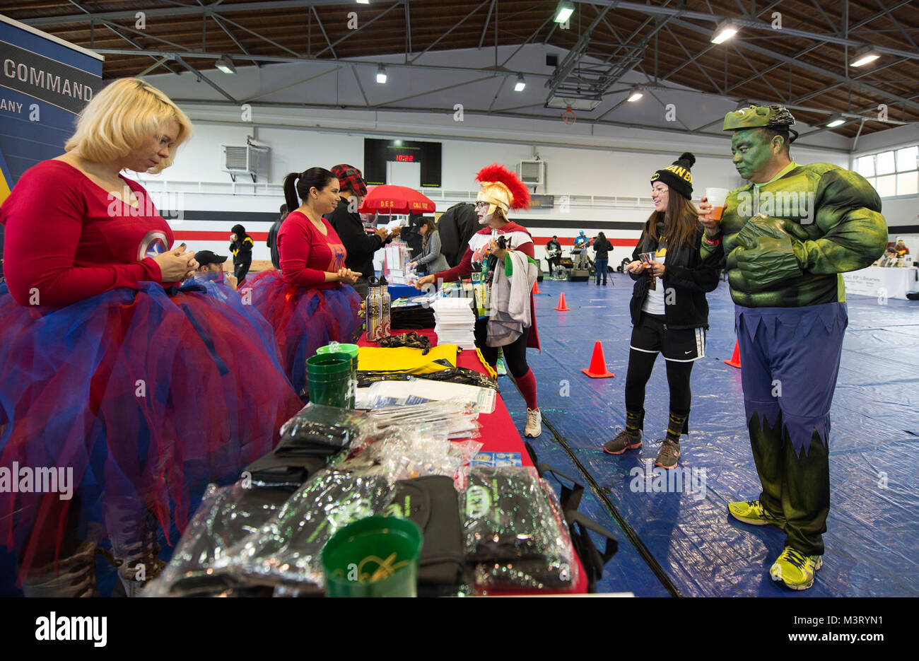 Red Ribbon Run Venders hand out gift bags to participants of a Red Ribbon Run ...