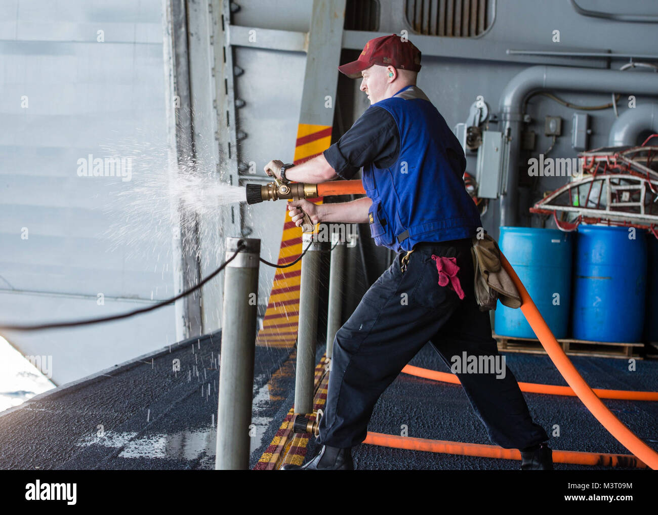 151106-N-XX655-016 PACIFIC OCEAN  (Nov. 6, 2015) - Damage Controlman 3rd Class Donald Swanson, from Sonora, Calif., drains water from a fire hose after hydrostatically testing it in USS John C. Stennis' (CVN 74) hangar bay. Hydrostatic tests ensure fire hoses will work safely with pressurized water. Sailors from the John C. Stennis Strike Group are participating in a sustainment training exercise (SUSTEX) to prepare for future deployments. (U.S. Navy photo by Mass Communication Specialist 3rd Class Andre T. Richard/ Released) 151106-N-XX655-016 by USS John C. Stennis (CVN 74) Official Stock Photo