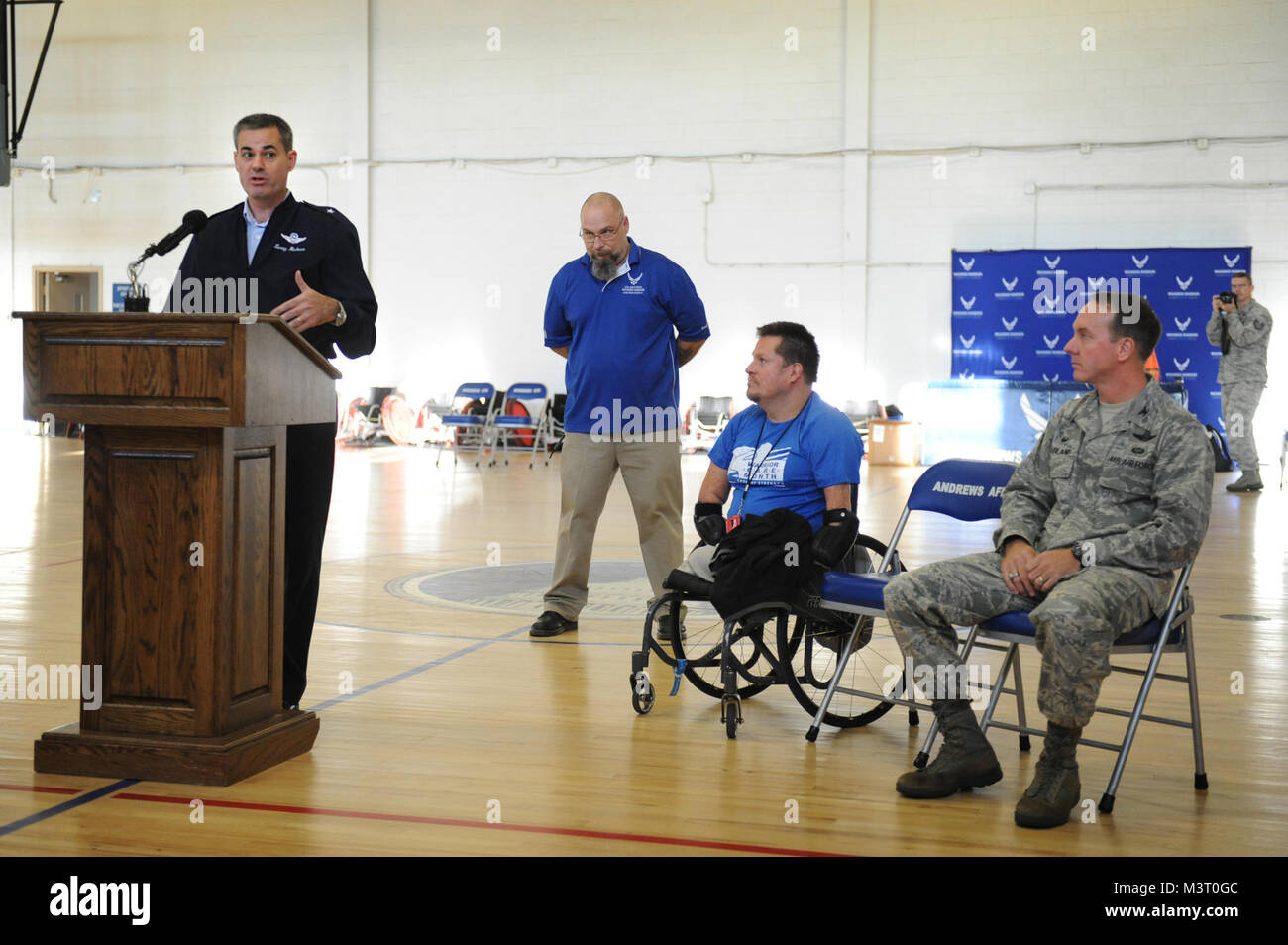 Air Force Brigadier General, Lenny Richoux, Director, Air Force Services, makes opening remarks as (L-R) Mr. Shawn Sprayberry, Communications and Outreach Coordinator, Mr. Bob Lujano, President, US Quad Rugby Association, and Air Force Col. Bradley Hoagland, 11th Wing and Joint Base Andrews Commander, listen in during the opening ceremony of the Joint Services Wheelchair Rugby Exhibition/Warrior Care Month 2015 at Joint Base Andrews, Maryland.  (Department of Defense photo by Marvin Lynchard) 151116-D-FW736-003 by DoD News Photos Stock Photo