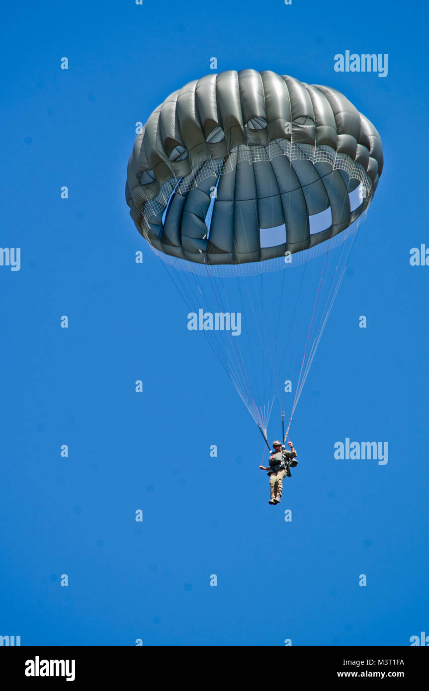 A U.S. Army Soldier with Special Operations Command South (Forward) 7310 prepares to land during a static-line training jump Jan. 11, 2016 at Soto Cano Air Base, Honduras. The training jump gave the SOC FWD members a chance to remain current on their jump requirements, while also training with their Honduran counterparts. (U.S. Air Force photo by Capt. Christopher Mesnard/Released) 160111-F-DT859-011 by ussouthcom Stock Photo