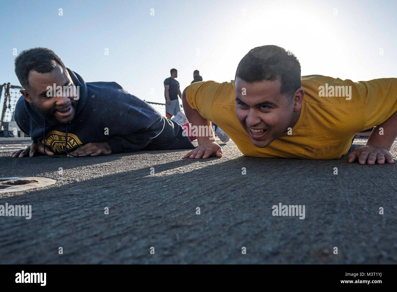 160219-N-MD297-055 PACIFIC OCEAN (Feb. 17, 2016) - Culinary Specialist 3rd Class Carlos Guajardo, right, and Engineman 3rd Class Derrell Johnson motivate each other during a Squid Fit class aboard Arleigh Burke-class guided-missile destroyer USS Lassen (DDG 82). Lassen is currently underway in support of Operation Martillo, a joint operation with the U.S. Coast Guard and partner nations within the 4th Fleet area of responsibility. Operation Martillo is being led by Joint Interagency Task Force South, in support of U.S. Southern Command. (U.S. Navy photo by Mass Communication Specialist 2nd Cla Stock Photo