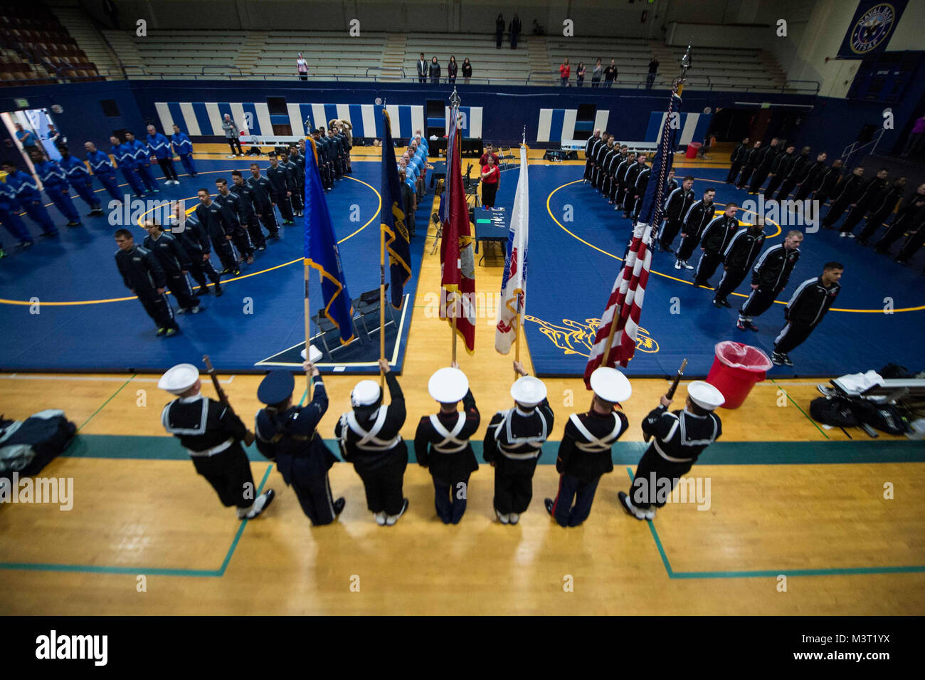 160220-N-OO032-033 BREMERTON, Wash. (Feb 20, 2016) - An Armed Forces color guard presents the colors during the aational anthem for the opening ceremony of the 2016 Armed Forces Wrestling Championship Greco-Roman wrestling tournament at Naval Base Kitsap-Bremerton. The tournament is held over two days, one for Greco-Roman style wrestling and the other freestyle, between the Army, Navy, Marine Corps and Air Force. It's an Olympic qualifier for participants wrestling Greco-Roman. (U.S. Navy photo by Mass Communication Specialist 2nd Class Cory Asato/Released) 160220-N-OO032-033 by Naval Base Kit Stock Photo
