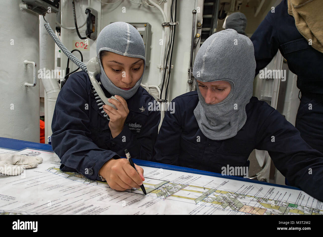 160311-N-MD297-088 PACIFIC OCEAN (March 11, 2016) - Yeoman Seaman Christine Quinn, left, and Gas Turbine Systems Technician (Mechanical) Fireman Dickie updates a damage control chart during a main space fire drill aboard the Arleigh Burke-class guided-missile destroyer USS Lassen (DDG 82). Lassen is deployed to the U.S. 4th Fleet area of responsibility supporting law enforcement operations as part of Operation Martillo. (U.S. Navy photo by Mass Communication Specialist 2nd Class Huey D. Younger Jr./Released) 160311-N-MD297-088 by U.S. Naval Forces Southern Command  U.S. 4th Fleet Stock Photo