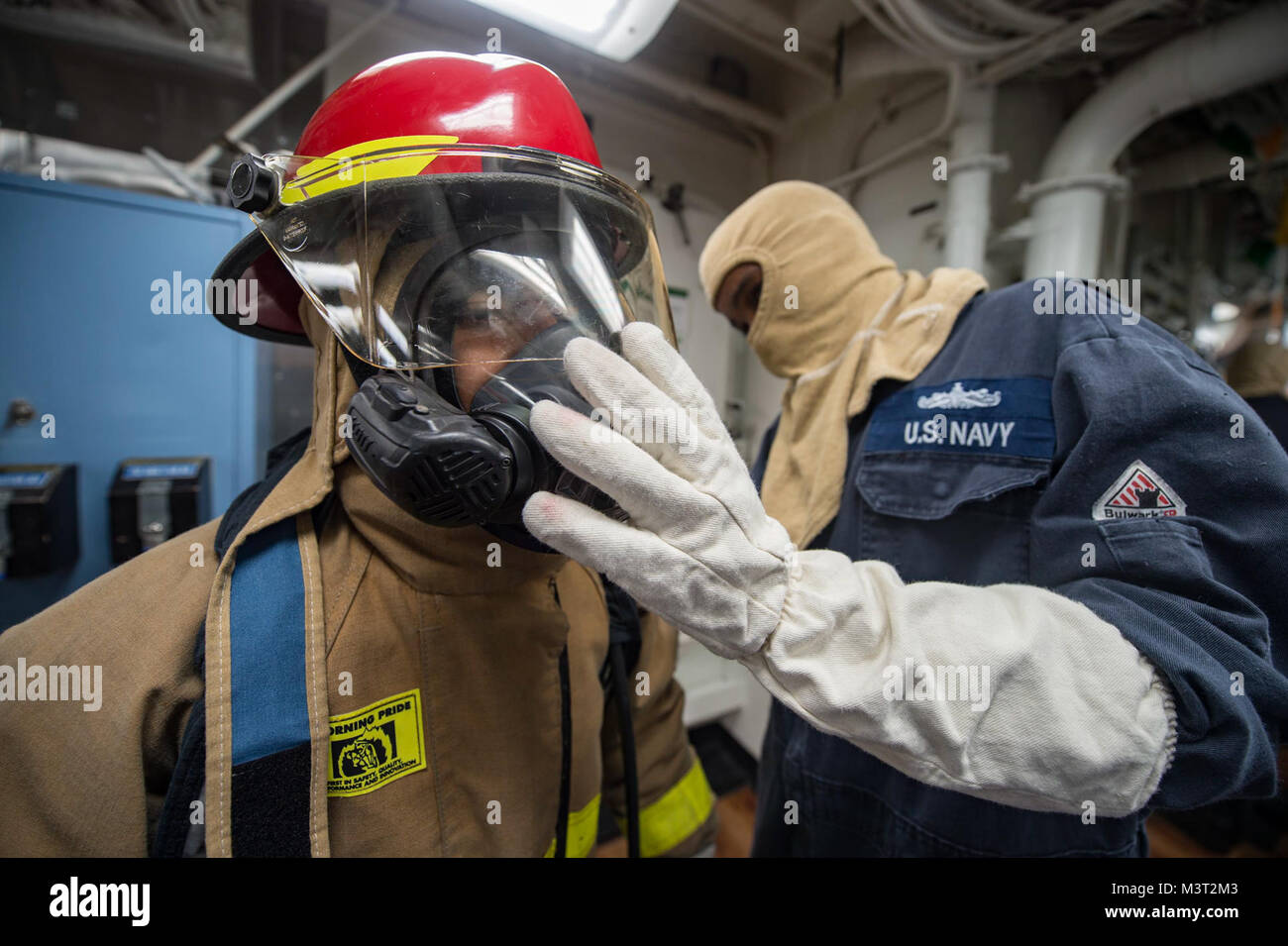160311-N-MD297-110 PACIFIC OCEAN (March 11, 2016) - Machinist's Mate 2nd Class Daurone Willis inspects Gas Turbine Systems Technician (Mechanical) Fireman John Turner for the proper wear of a firefighting ensemble during a main space fire drill aboard Arleigh Burke-class guided-missile destroyer USS Lassen (DDG 82). Lassen is deployed to the U.S. 4th Fleet area of responsibility supporting law enforcement operations as part of Operation Martillo. (U.S. Navy photo by Mass Communication Specialist 2nd Class Huey D. Younger Jr./Released) 160311-N-MD297-110 by U.S. Naval Forces Southern Command  U Stock Photo