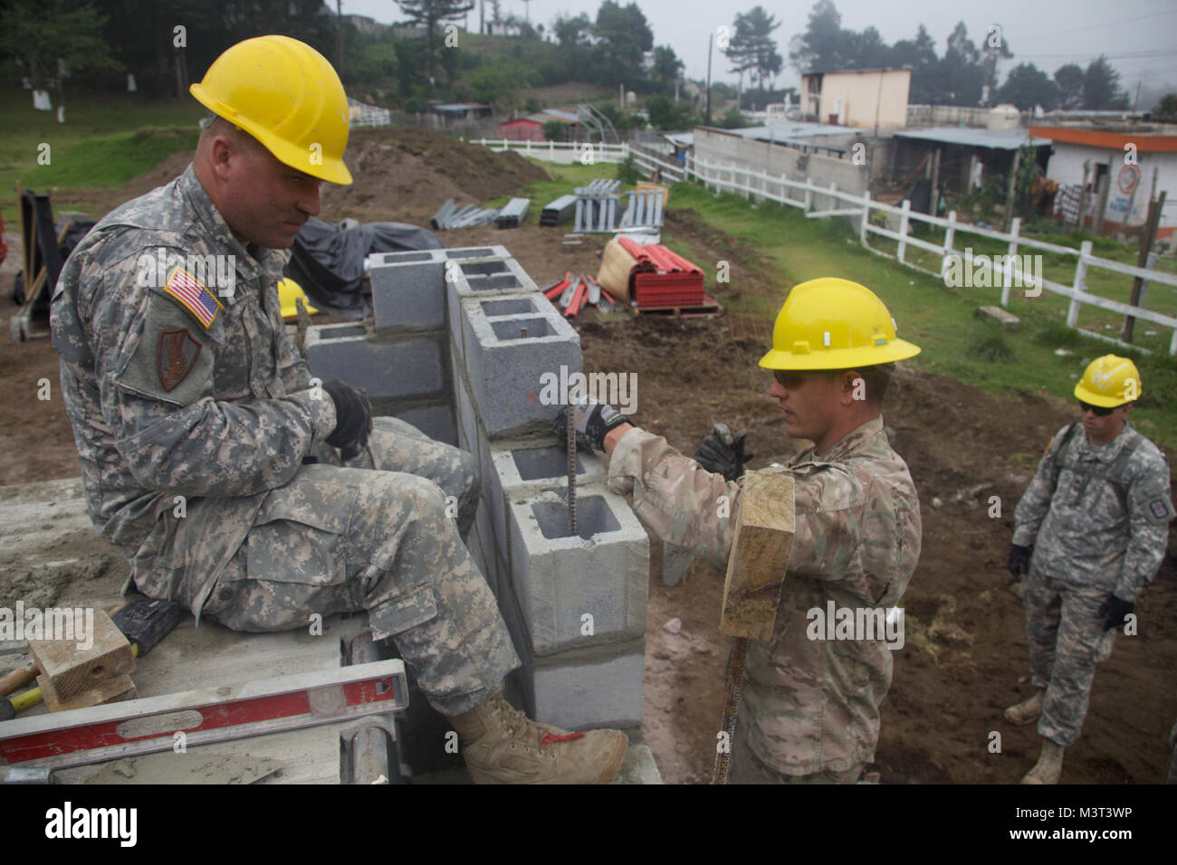 U.S. Army Engineers lay brick at the Palo Gordo Clinic Building Site as part of the Beyond The Horizon Operation at Palo Gordo, Guatemala, April 25, 2016. Task Force Red Wolf and Army South conducts Humanitarian Civil Assistance Training to include tactical level construction projects and Medical Readiness Training Exercises providing medical access and building schools in Guatemala with the Guatemalan Government and non-government agencies from 05MAR16 to 18JUN16 in order to improve the mission readiness of US forces and to provide a lasting benefit to the people of Guatemala. (U.S. Army phot Stock Photo