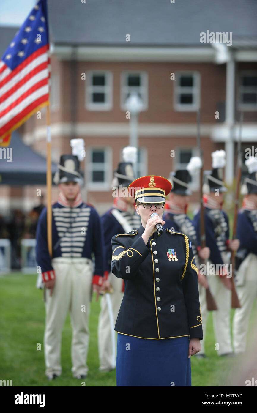 Master Sgt. Christal Rheams,  vocalist, U.S. Army Band “Pershing’s Own), along with 1812 period uniformed soldiers from the 3rd U.S. Infantry Regiment (The Old Guard) perform the National Anthem during Twilight Tattoo 2016 Media Preview Day at Summerall Field, Joint Base Myer-Henderson Hall, Virginia.  Twilight Tattoo, presented on behalf of the U.S. Army, is a fast paced journey that captures 241 years of Soldiers’ stories spanning across generations of men and women who have answered the call to uphold America’s freedom and democracy. The program showcases The Old Guard’s Continental Color G Stock Photo