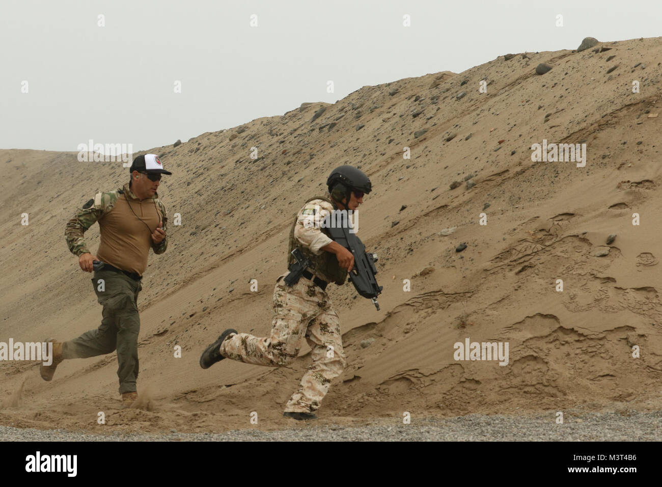 A Mexican competitor rounds a sand mound during the assault team event ...