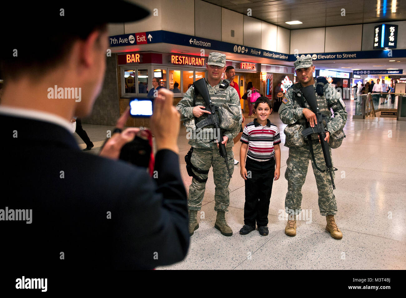 JTF Empire Shield members pose for pictures with tourists at Penn Station. Pictures are a