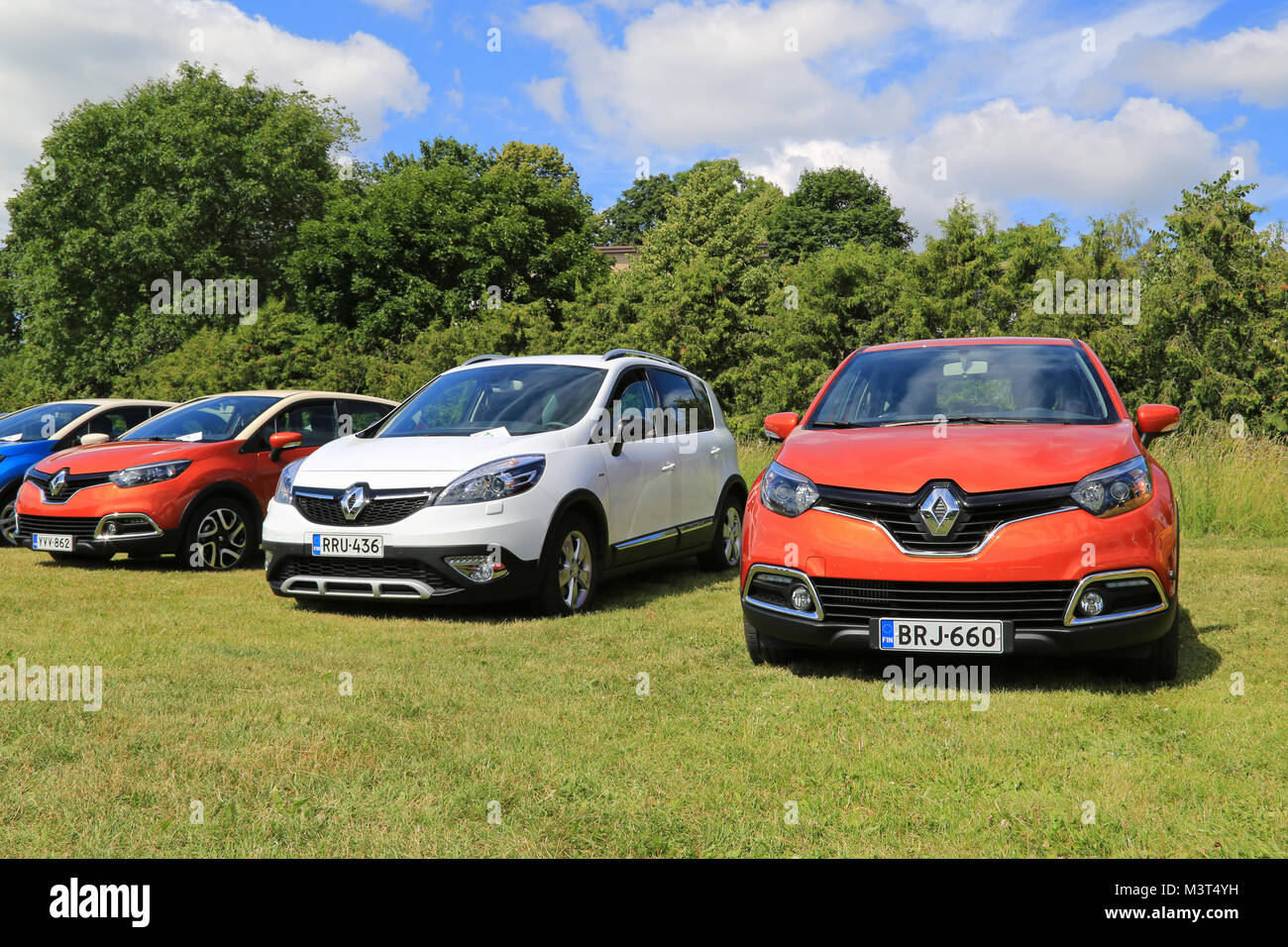 PIIKKIO, FINLAND - JULY 19, 2014: Red Renault Captur Cars and a White Scenic Xmod on display. Renault Captur wins its category in the influential Tow  Stock Photo
