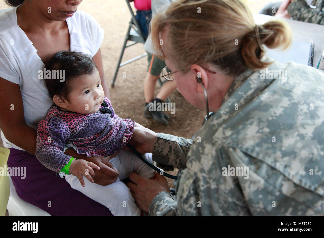 U.S. Army Capt. Rose Fisher, with the 396th Combat Support Hospital Company, checks a patient's heartbeat during a medical readiness exercise at San Padro, Guatemala, May 17, 2016. Task Force Red Wolf and Army South conducts Humanitarian Civil Assistance Training to include tactical level construction projects and Medical Readiness Training Exercises providing medical access and building schools in Guatemala with the Guatemalan Government and non-government agencies from 05MAR16 to 18JUN16 in order to improve the mission readiness of US forces and to provide a lasting benefit to the people of  Stock Photo