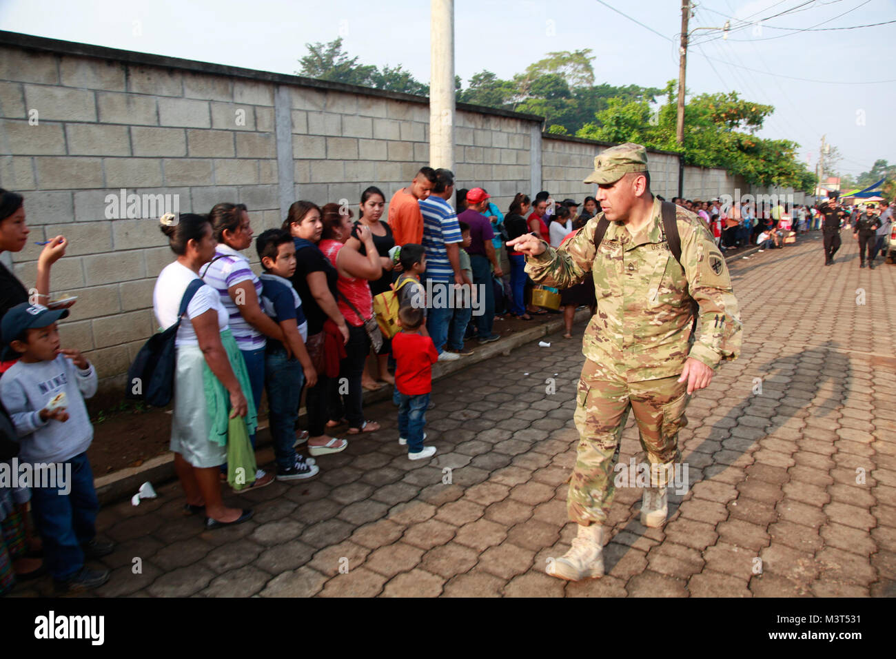 U.S. Army Sgt. First Class Luis Villarreal, with the 345th Tactical Psychological Operations Company, performs a headcount of Guatemalan citizens during a medical readiness exercise at San Padro, Guatemala, May 17, 2016. Task Force Red Wolf and Army South conducts Humanitarian Civil Assistance Training to include tactical level construction projects and Medical Readiness Training Exercises providing medical access and building schools in Guatemala with the Guatemalan Government and non-government agencies from 05MAR16 to 18JUN16 in order to improve the mission readiness of US forces and to pro Stock Photo