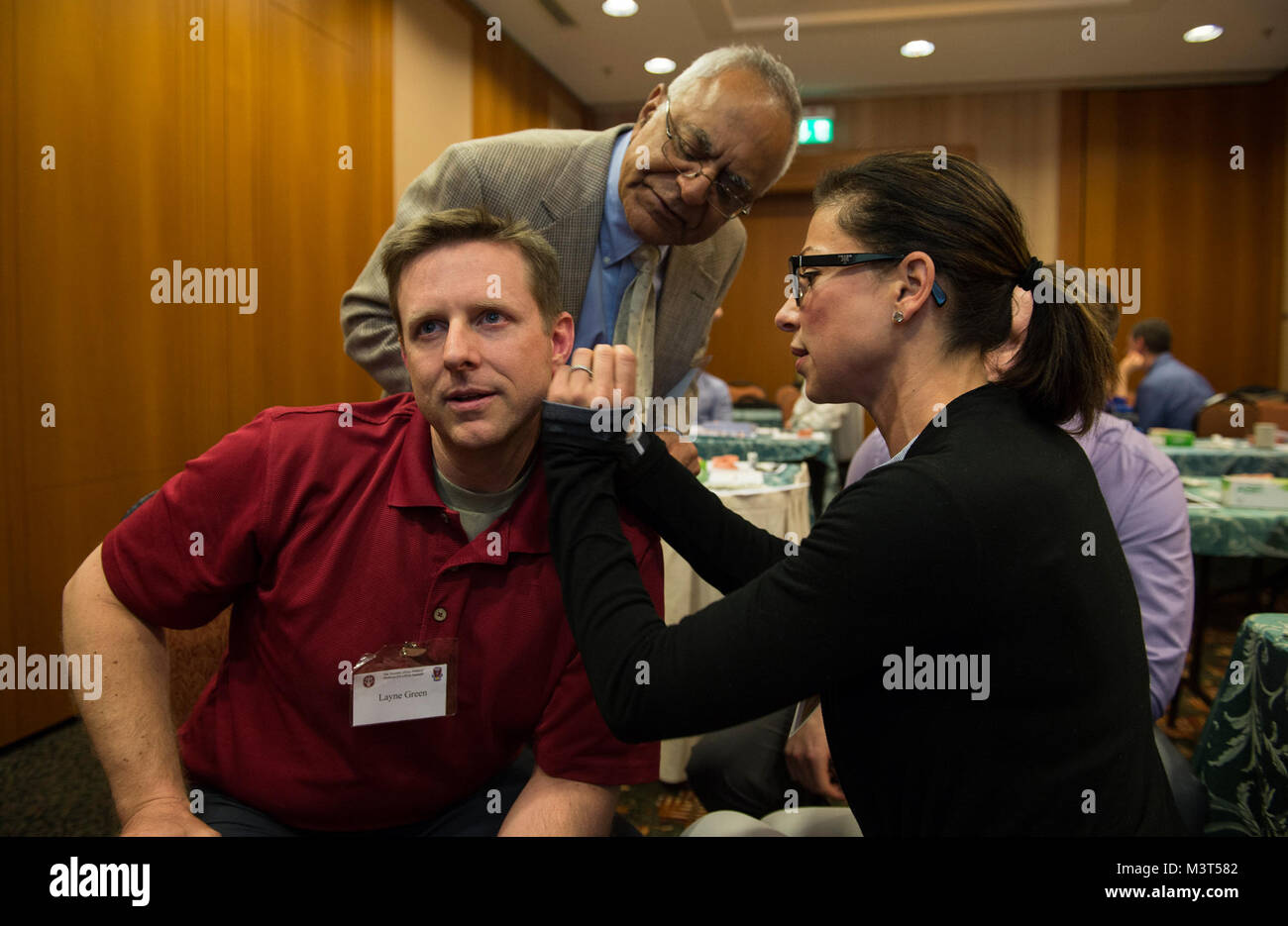 Mrs. Simone Coderellis (Right), A Physician's Assistant, Applies  Acupuncture To The Ear Of U.s. Air Force Major Layne Green, A Dermatologist,  During The 2016 European African Military Nursing Exchange (Eamne)  Conference And