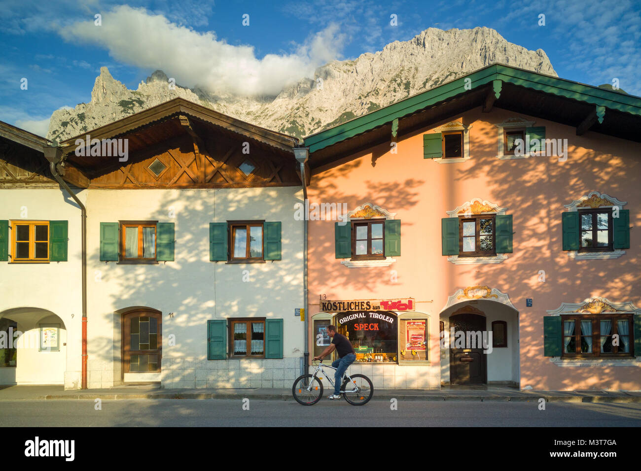 Typical bavarian country houses with distant mountain top and cloud in Mittenwald, Germany Stock Photo