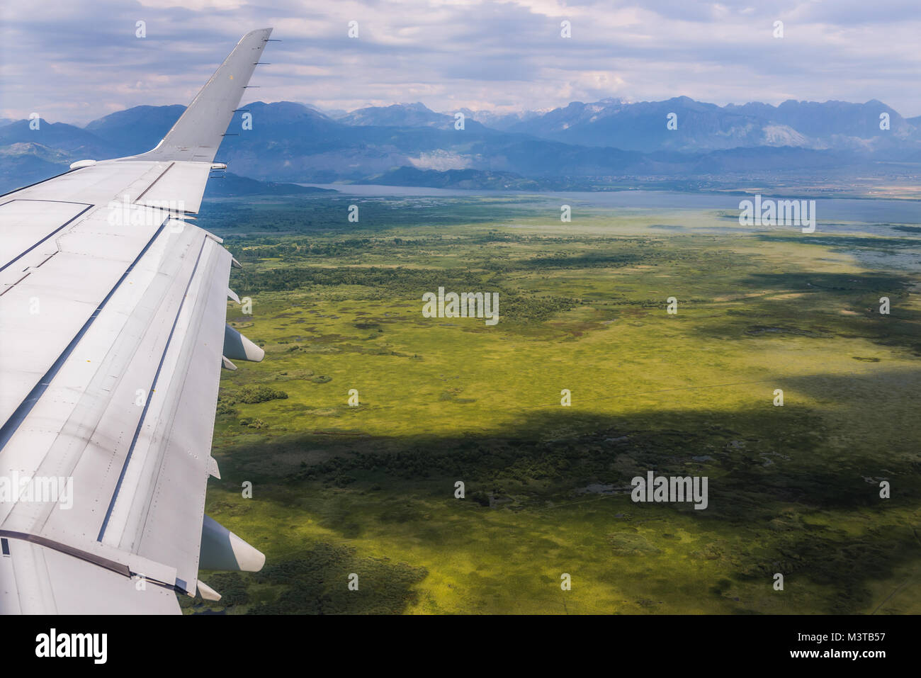 View from plane on a green aera of Zeta Plain near Lake Skadar during flight above Montenegro Stock Photo