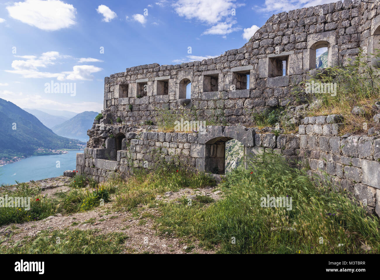 Remains of walls of Saint John Fortress on the mount aobve Kotor coastal city, located in Bay of Kotor of Adriatic Sea, Montenegro Stock Photo