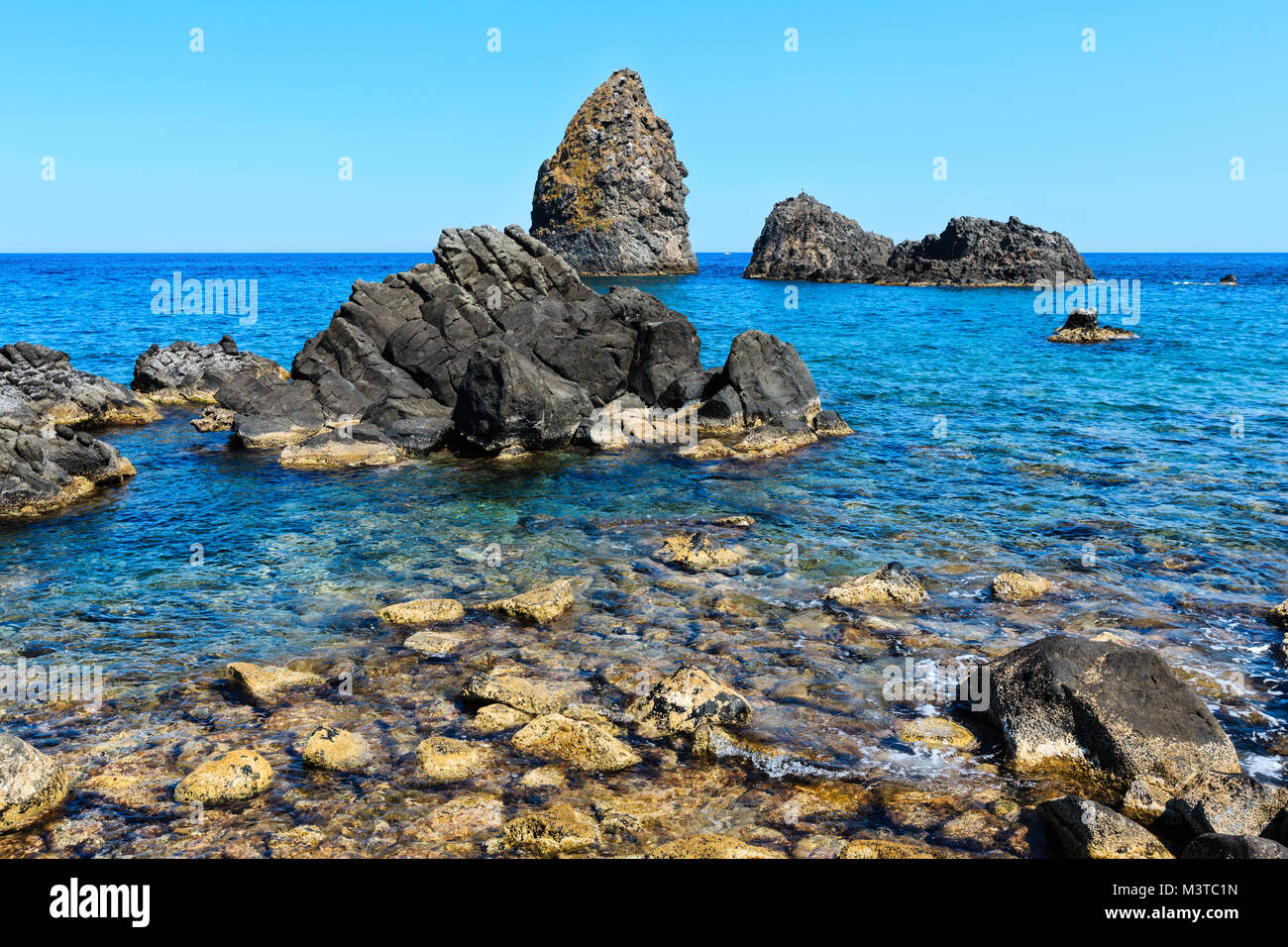 Cyclopean Coast and the Islands of the Cyclops on Aci Trezza town (Italy,  Sicily,10 km north of Catania). Known as Isoles Dei Ciclopi Faraglioni  Stock Photo - Alamy