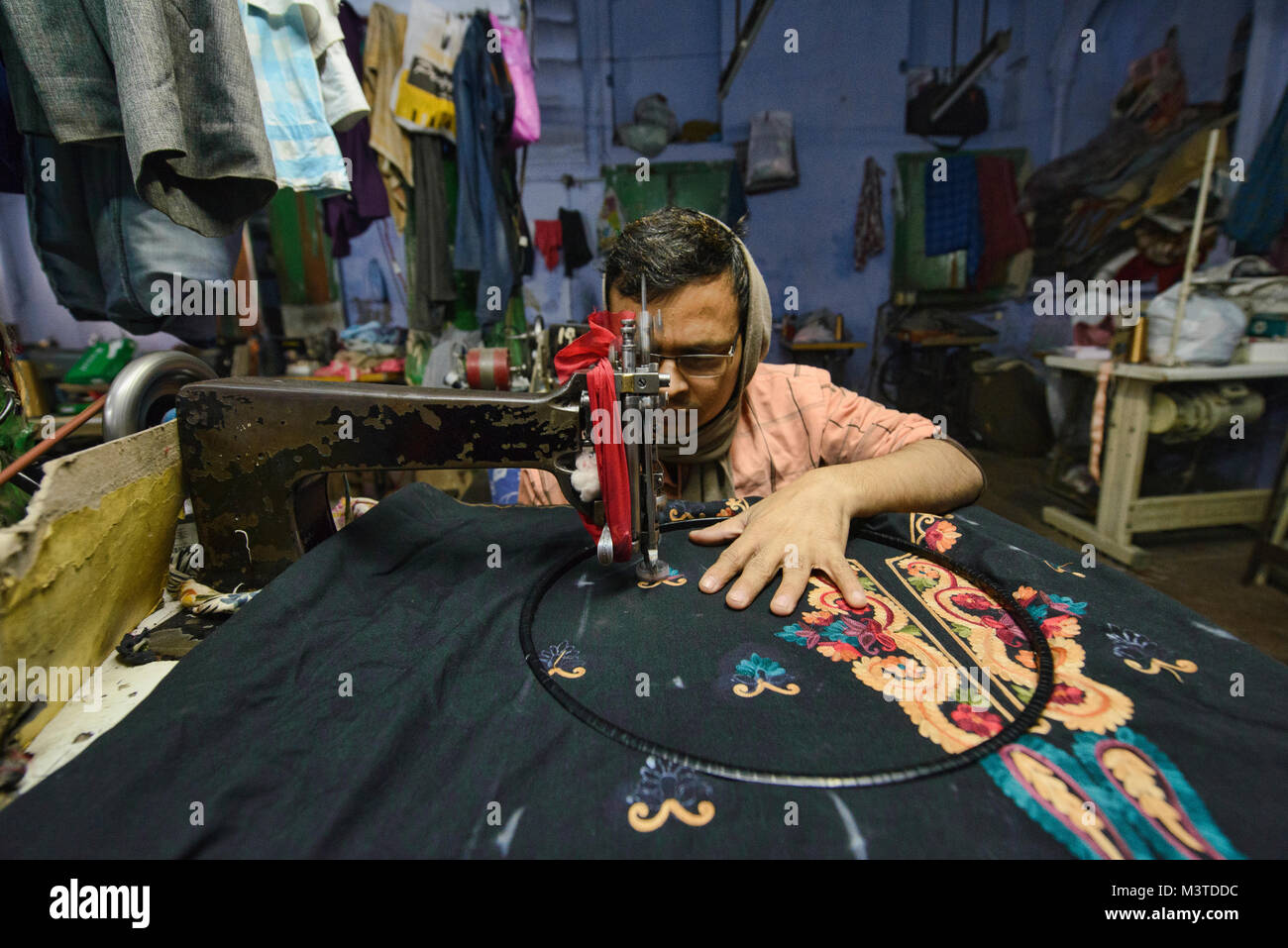 Expert stitcher at work in a garment factory in Old Delhi, India Stock Photo