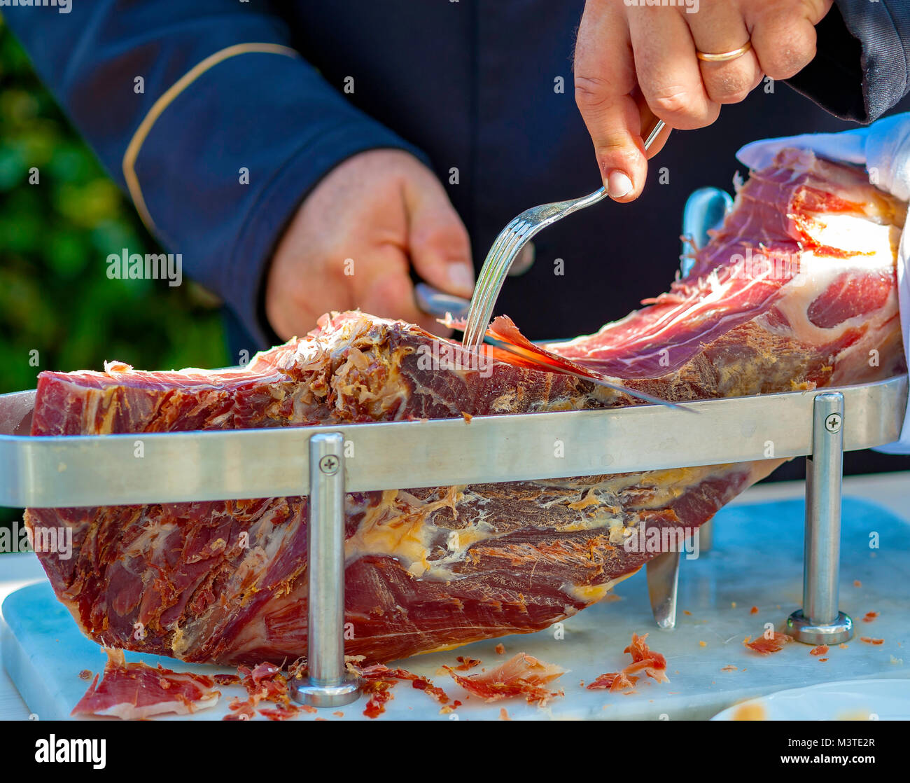 Waiter is slicing raw ham,italian Stock Photo