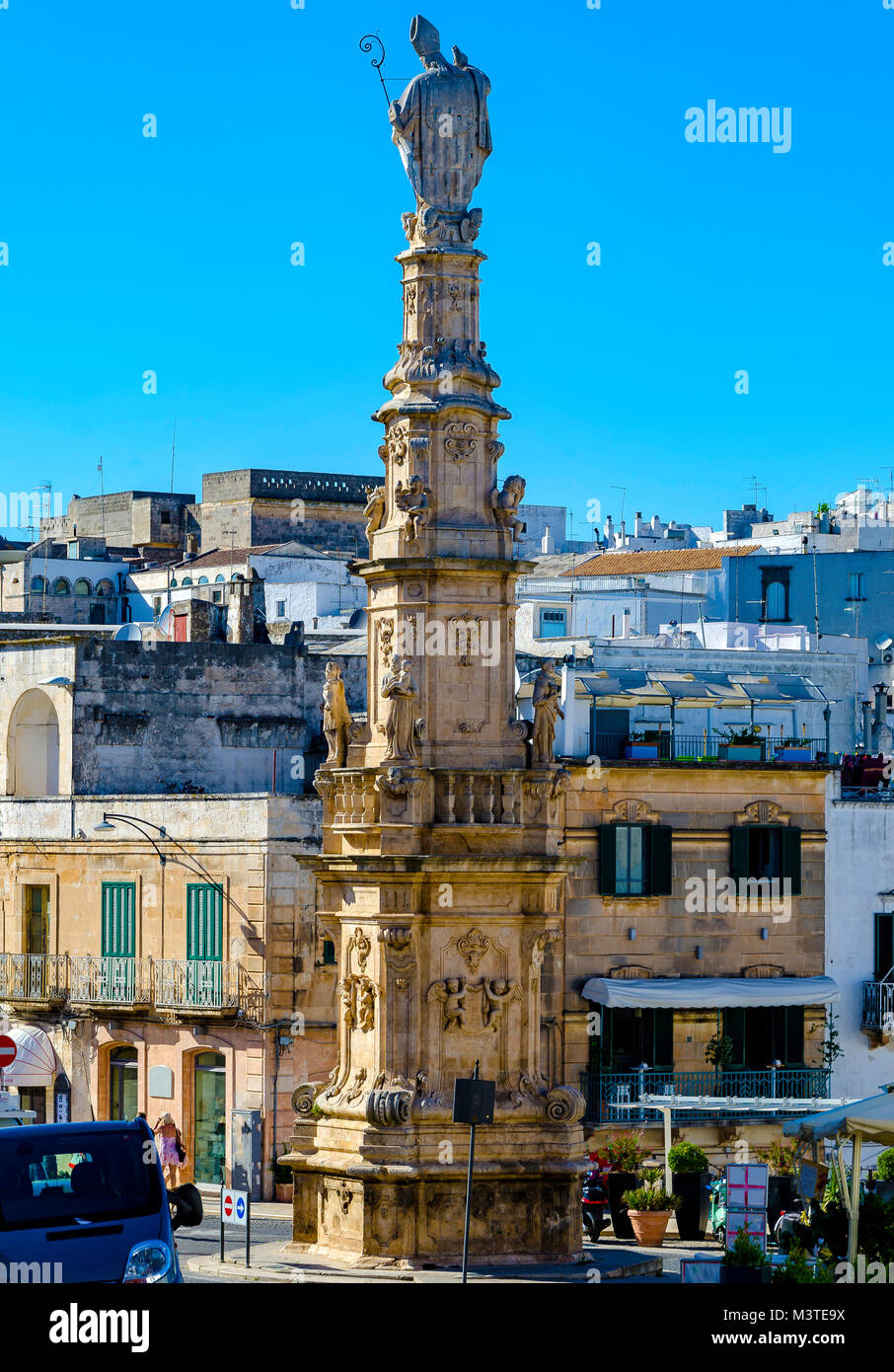 View on the Statue of San Oronzo and the Old Town of Ostuni, Puglia, Italy. Stock Photo