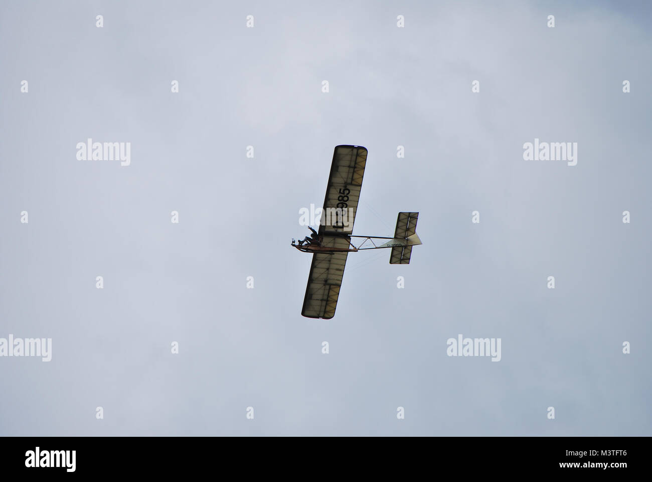 very old aircraft flying slowly and at a high pass pilot greets flugshow Stock Photo