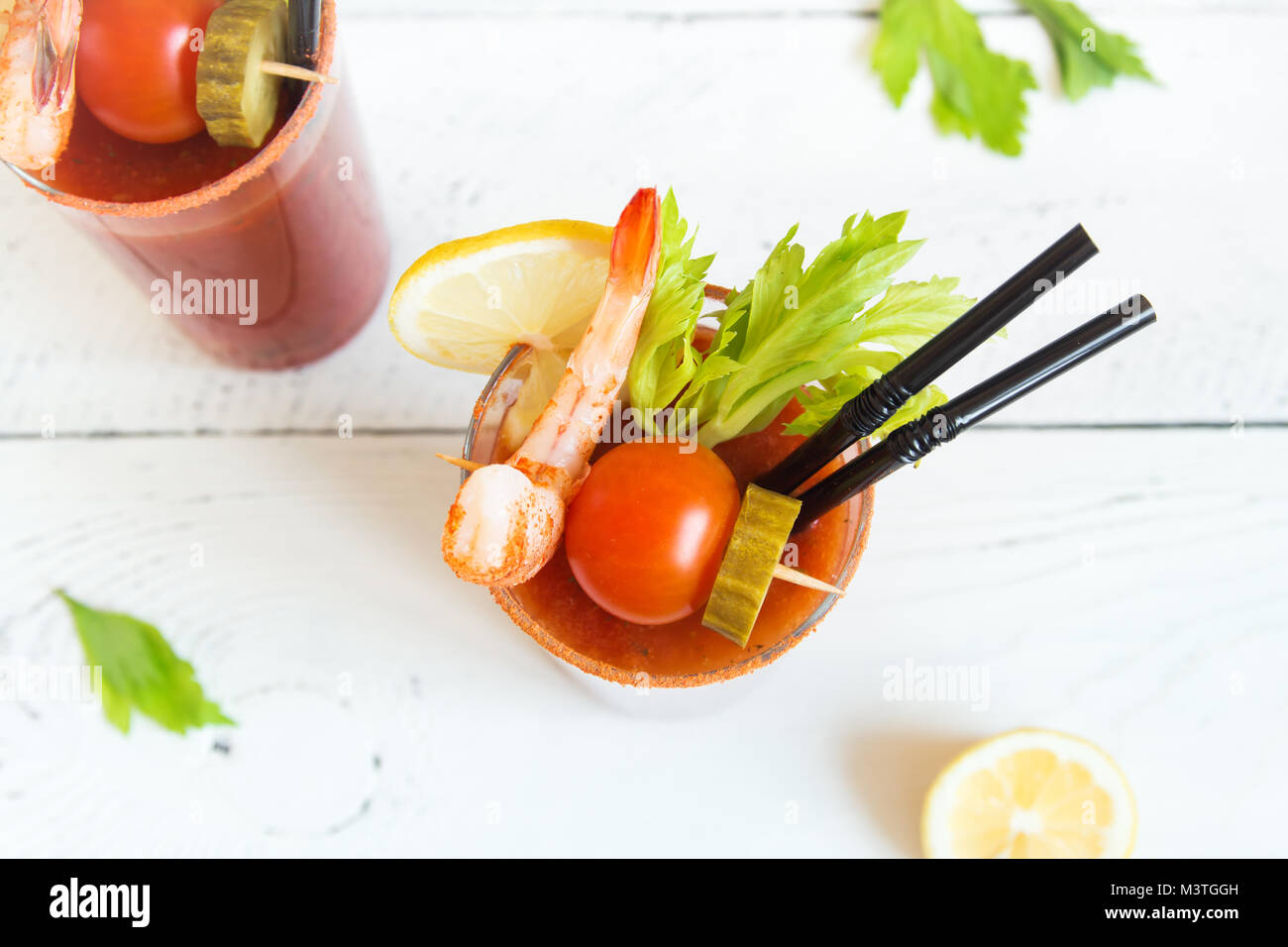 Bloody Mary Cocktail in glasses with garnishes. Tomato Bloody Mary spicy  drink on black stone background with copy space Stock Photo - Alamy