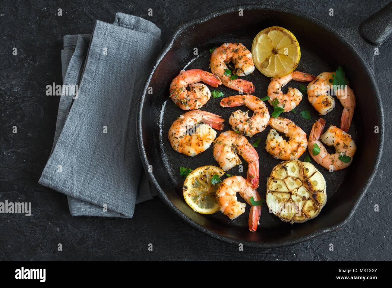 Roasted shrimps with lemon, garlic and herbs. Seafood, shelfish. Shrimps Prawns grilled with