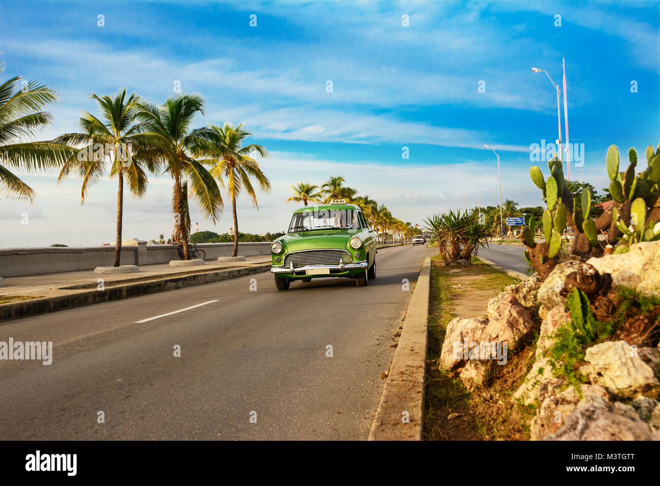 Old green American car on the Cienfuegos Malecon Stock Photo